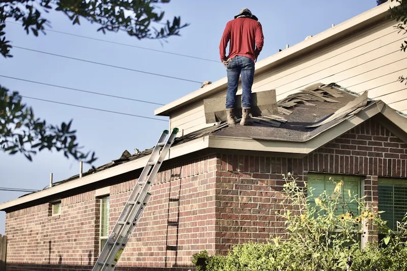 Professional roofer working on a residential roof in Patchogue Highlands